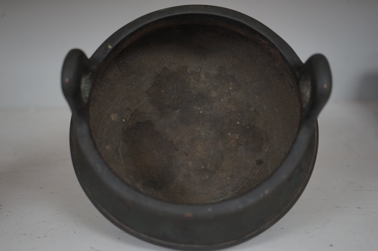 A Chinese bronze censer, character mark to base, 14cm. Condition - fair to good